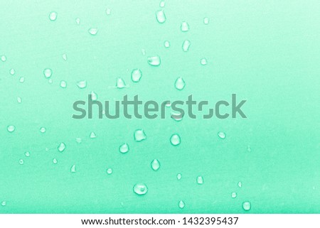 Drops of water on a color background. Green. Toned.