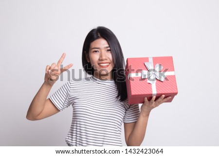 Young Asian woman show Victory sign with a gift box on white background