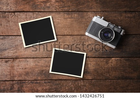 Vintage camera with empty photo frames. Top view