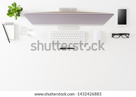 Office desktop with computer and accessories. Top view