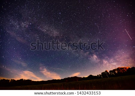 Midsummer Milky Way and satellite light in the night sky.