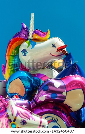 Metallic colored balloons with blue sky background