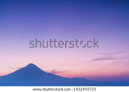 Silhouette mount Merapi before sunrise appears from the hill of Puthuk Setumbu.