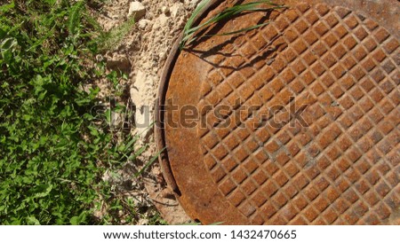 old and rusty manhole on the street top view