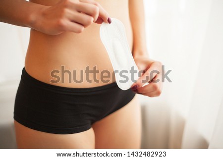 Closeup Of Beautiful Woman Body In Underwear Holding Panty Liner