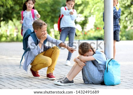 Bullied little girl with aggressive schoolmates outdoors Royalty-Free Stock Photo #1432491689