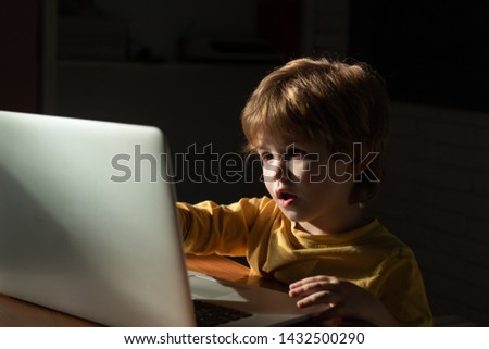 Child at home using a laptop for watching cartoons. Interesting information on the Internet for children. Internet Security. Cyber threat.