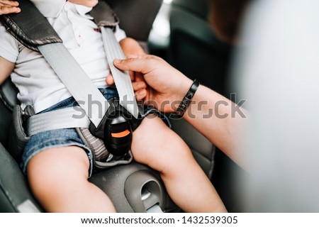 details of child car seat with baby inside, seatbelt and safety  Royalty-Free Stock Photo #1432539305