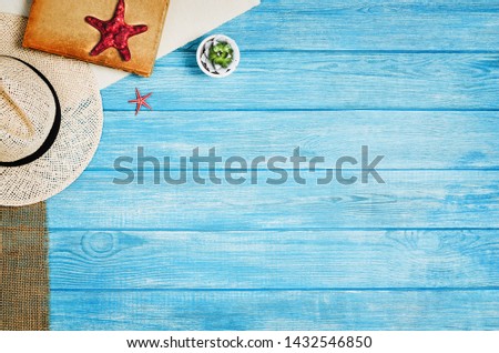 Accessories for travel top view on blue wooden background with copy space. Adventure and wanderlust concept image with travel accessories. Preparing for an exotic trip, journey and sightseeing.