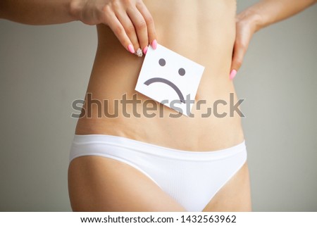 Woman Health. Female Body Holding Sad  Card Near Stomach