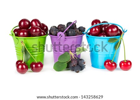 Three buckets with berries isolated on white background