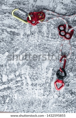 Champion gear. Isolated photo of climbing equipment. Part of carabiner lying on the white and grey colored table.