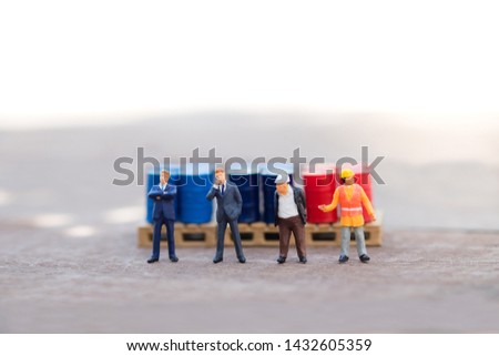 Miniature people : Business man and engineer standing in front of drums with copy space, business, industrial concept