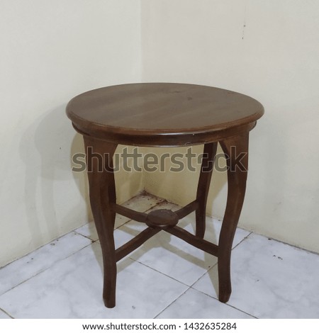 antique wooden round table in the room corner