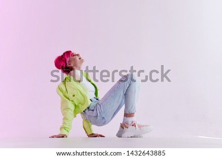 a woman with pink hair leaned on the floor