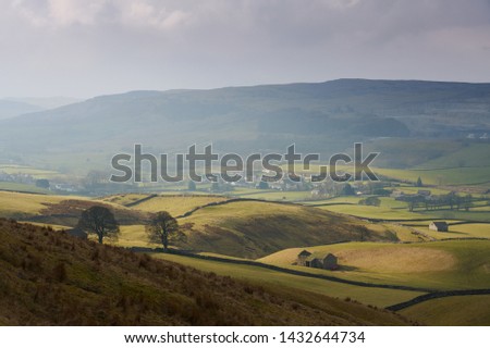 Views out over farmland and farm buildings near Horton in Ribblesdale, Yorkshire Dales. Royalty-Free Stock Photo #1432644734