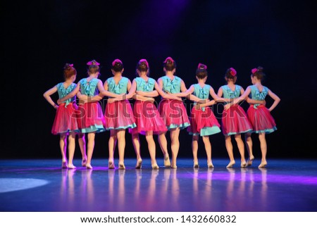 
Eight girls dancing on stage. Royalty-Free Stock Photo #1432660832