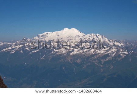 Sunny day at the snowy mountains with view on the mountain Elbrus
