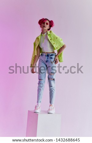 woman with pink hair stands in a cube fashion style