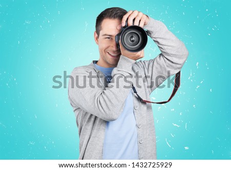 Male Photographer with Camera on light background