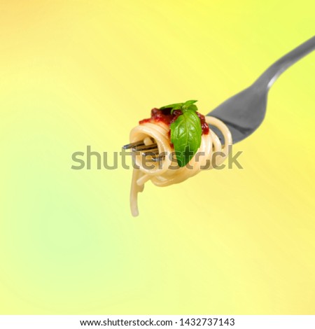 Close-up of fresh delicious pasta on fork on background