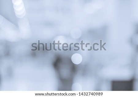 abstract blur bokeh background blue tone indoor in the shopping mall with many people.