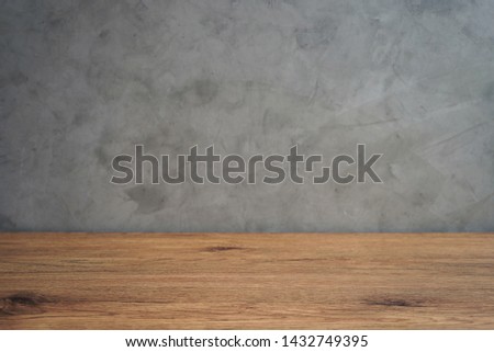 Empty wood table on expose concrete wall background                               