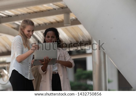 Two young girl using laptop and checking social media.