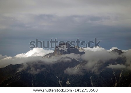 alps in the clouds on the evening