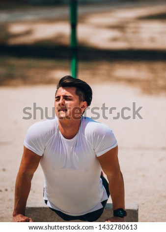 Fit man working out doing push-ups exercising outdoors