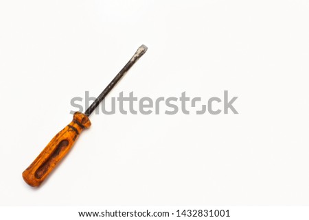 very old used screwdriver on a white background