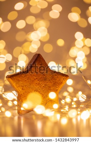 Christmas gold bokeh background with decorative star. Christmas gold stars. Christmas pattern. Background on the gray color. - Image