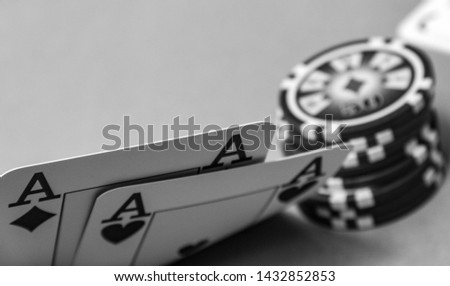 close up poker cards lifting corner. two aces. black and white photo