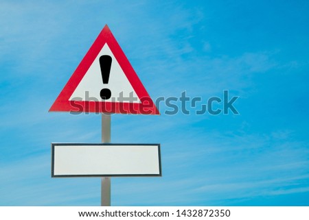 Exclamation point of attention against the sky. With a sign for text. triangular sign. Danger, warning.