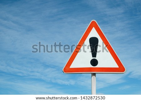 Exclamation point of attention against the sky. triangular sign. Danger, warning.