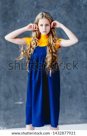 A girl in a long old fashioned dress with long hair