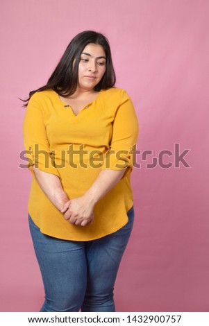 Chubby woman unsure of herself looking down isolated and rejected-curvy latina woman