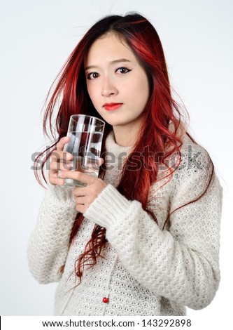 Asian women with red color long hair drinking water