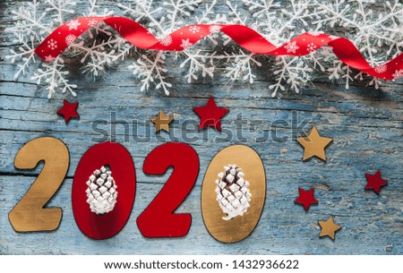 New year concept - Number 2020 for New Year and decoration on a wooden table. With vintage styled background.