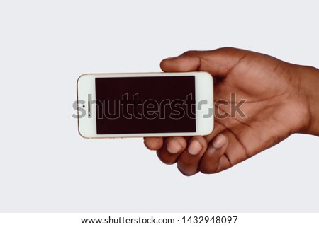 Male hand holding smartphone with blank screen. Isolated on white background.
