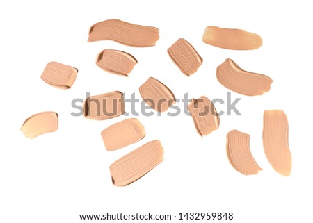 Liquid foundation smudge isolated on white background. Close Up of makeup cream sample.