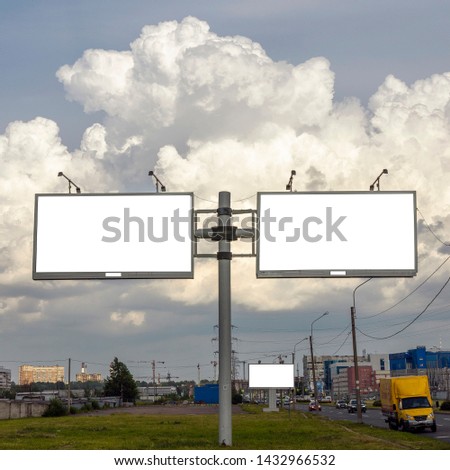 three billboards for advertising, text, illustrations and pictures on a background of beautiful thick clouds near the road. film effect