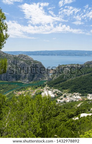 Beautiful nature and landscape photo of Omis in Dalmatia Croatia on warm summer day. Nice colorful image of mountains and Adriaic Sea.