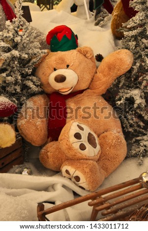 A giant Christmas teddy bear in a snowy winter wonderland.
