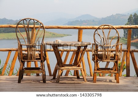 set of wicker deck chairs beside a wicker table 
