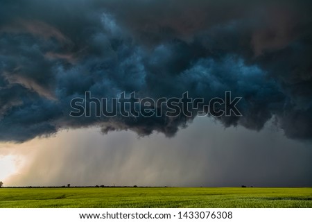Severe warned thunderstorm with shelf cloud moving through Cleo Springs, Oklahoma near sunset. Royalty-Free Stock Photo #1433076308