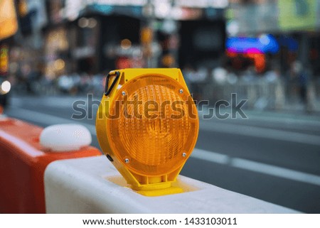 orange construction boards and flashing lights on city street