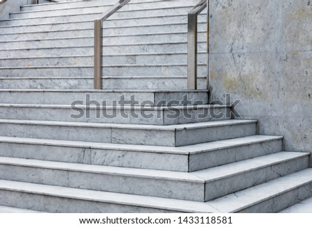 Modern marble staircase of the municipal administrative building with stainless steel handrails
