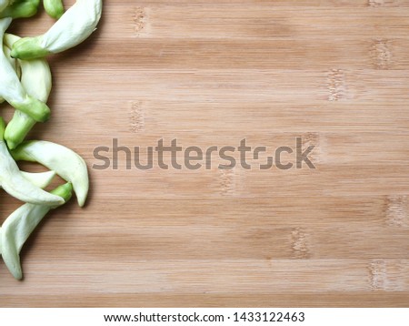 Agasta, Sesban, Vegetable humming bird on wooden bavkground, Top view with copy space, Can use as wallpaper or background.