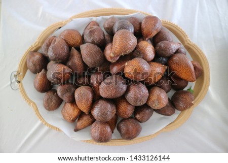 salak or snake skin fruit ( Salacca zalacca ) isolated on white